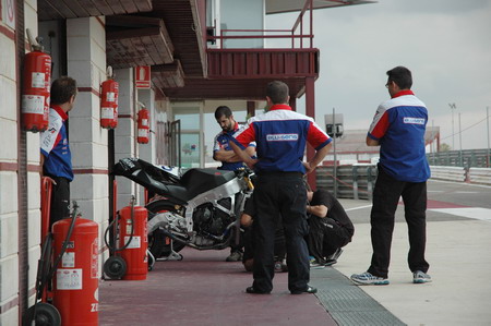 BQR team members looking at the LaGlisse Moto2 bike.